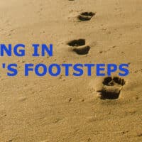 Photo of footsteps in the sand.