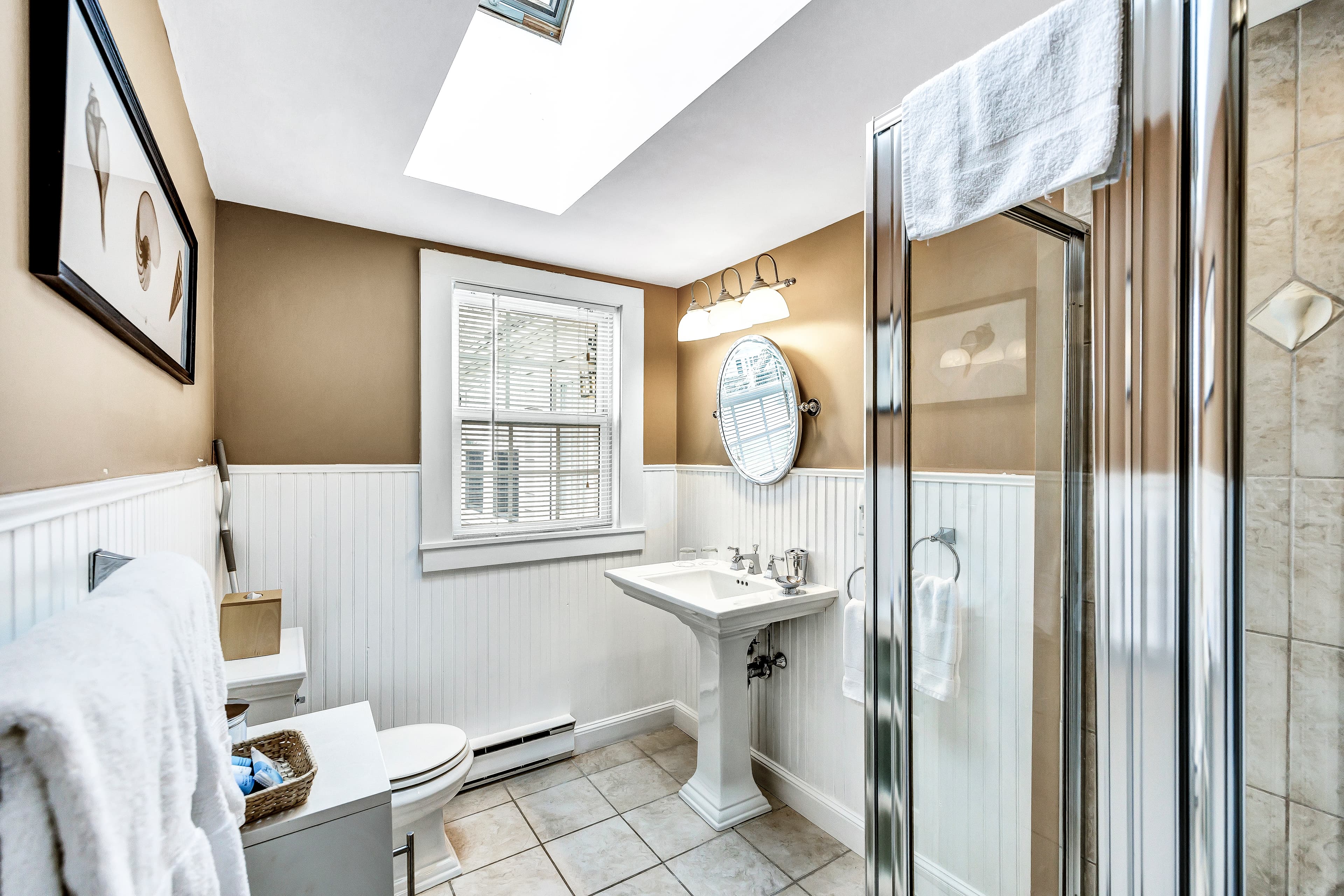step in enclosed shower unit, sink with mirror above, handtowels