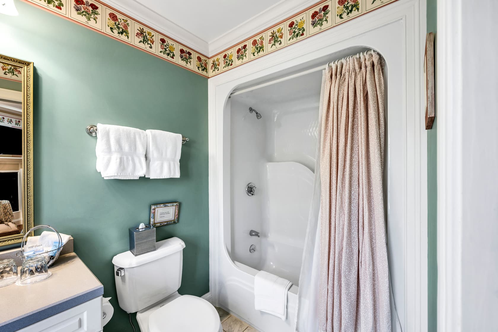 close up of tables and chairs on balcony with grass and trees beyond