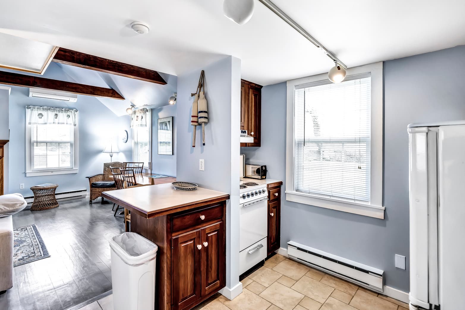 Bright, modern kitchen with wooden cabinets and open living space.