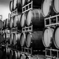 Black and white photo of stacked wine barrels.