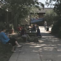 PHOTO OF SEVERAL CLASS PARTICIPANTS RELAXING OUTSIDE THE INSTITUTE.